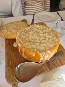 Risotto served inside a hollowed Parmesan wheel at Il Casone restaurant in Tuscany