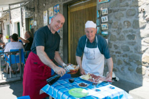 Silvano and Adriano outside their local bar in Castiglione, serving a traditional Tuscan marenda with bread, cured meats and wine.